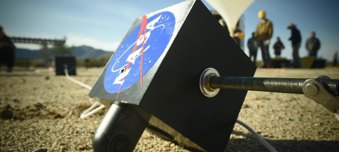 UA SEDS payload with NASA sticker. Background is helium balloon being inflated.