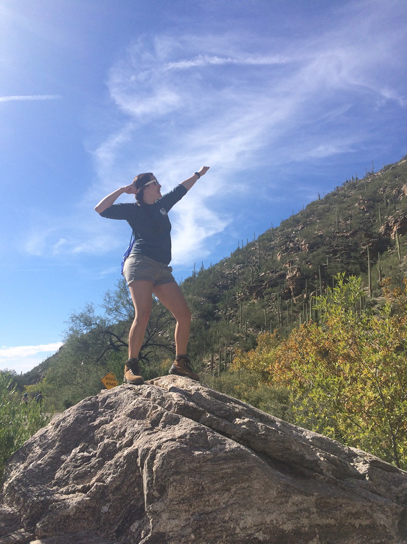Space Grant Intern Advisor, Emily Walla poses on a boulder.