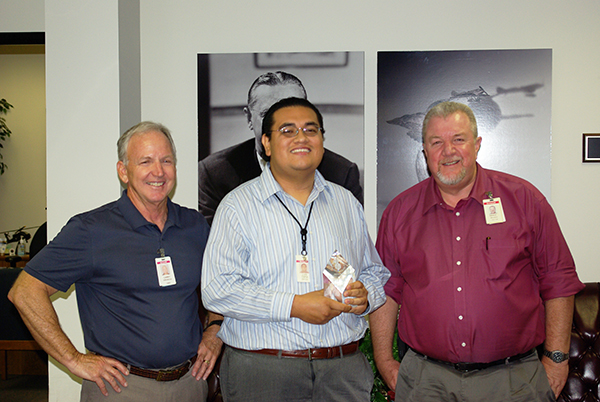 Luis Tapia holds Society of Hispanic Professional Engineers STAR Innovator Award, with two Honeywell employees