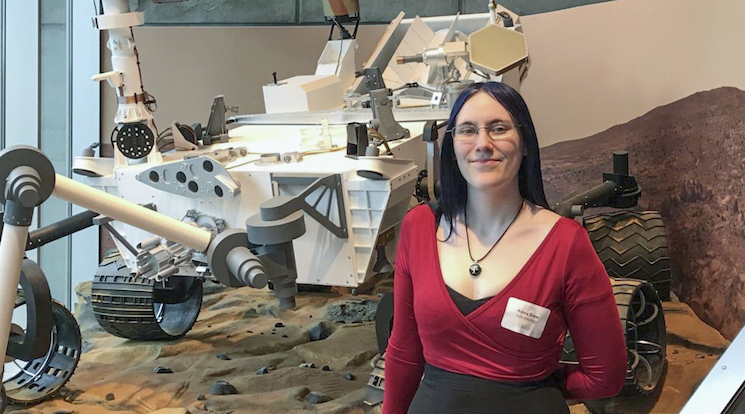 Alexa Drew poses in front of rover model