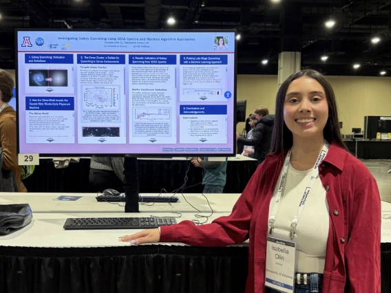 Isabella Olin stands in front of her digital poster at AAS conference