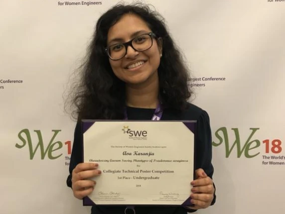 Ava Karanjia poses with her first-place award for the undergraduate collegiate technical poster competition at the Society of Women Engineers Conference.