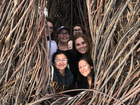 Victoria Girgis, Kathryn Tellez, Adriana Weise, Madelyn Hart, Hailey Osborn, Ariel Daniel pose inside tree art structure