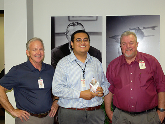 Luis Tapia holds Society of Hispanic Professional Engineers STAR Innovator Award, with two Honeywell employees