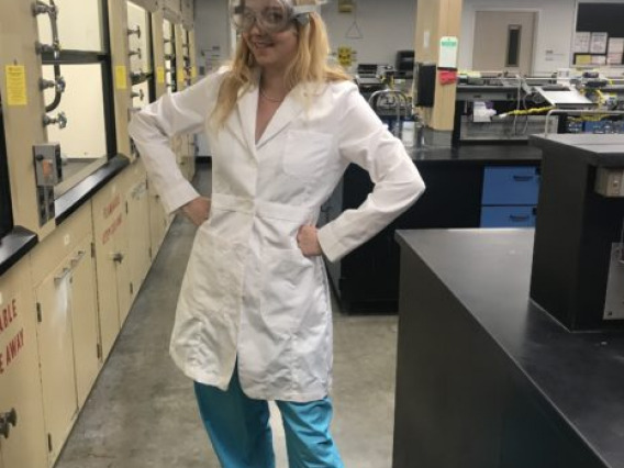 Ruby O'Brien-Metzger poses in the Superfund Dust Lab.
