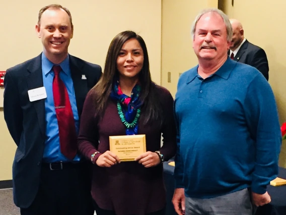 Rayanna Benally holds SNRE's Fall 2017 Outstanding Graduating Senior Award, with her mentor Steven Archer,  and Shane Burgess - Dean of College of Agriculture and Life Sciences