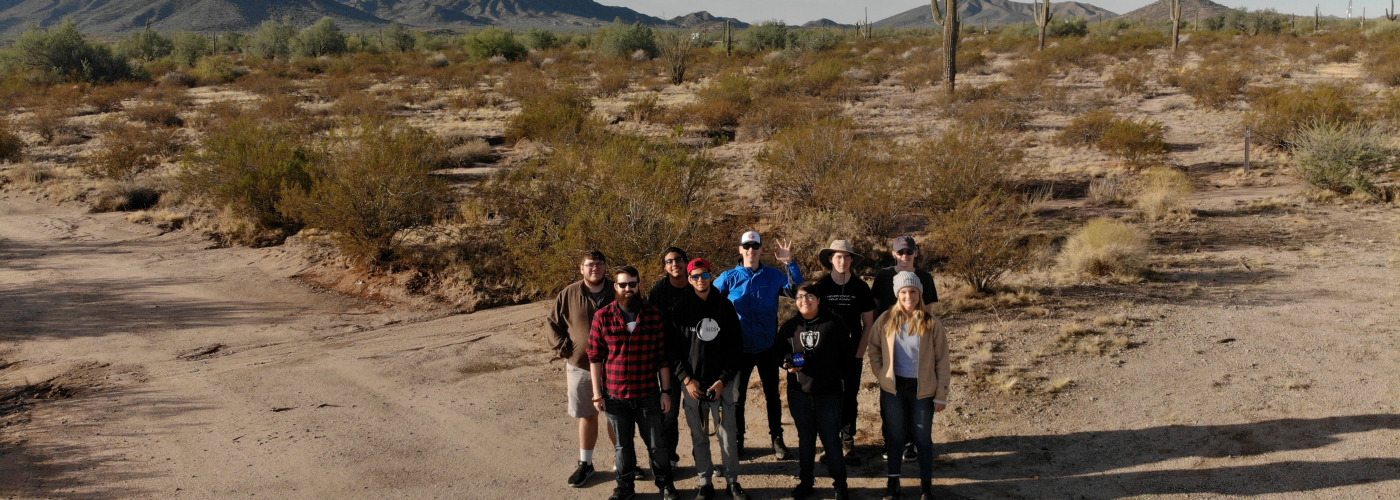 Eight University of Arizona Students for the Exploration and Development of Space ASCEND team together for picture in beautiful desert surrounding at Pinal County West Park before Fall 2019 launch.