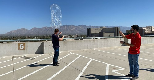 Student, Josh Crest, launchs pico balloon from rooftop. 