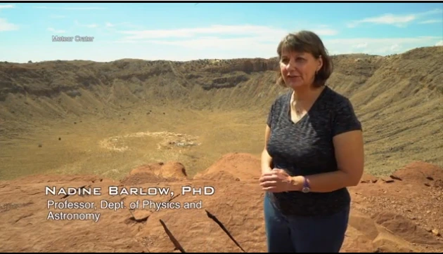 Nadine Barlow stands on the edge of Meteor Crater, AZ.