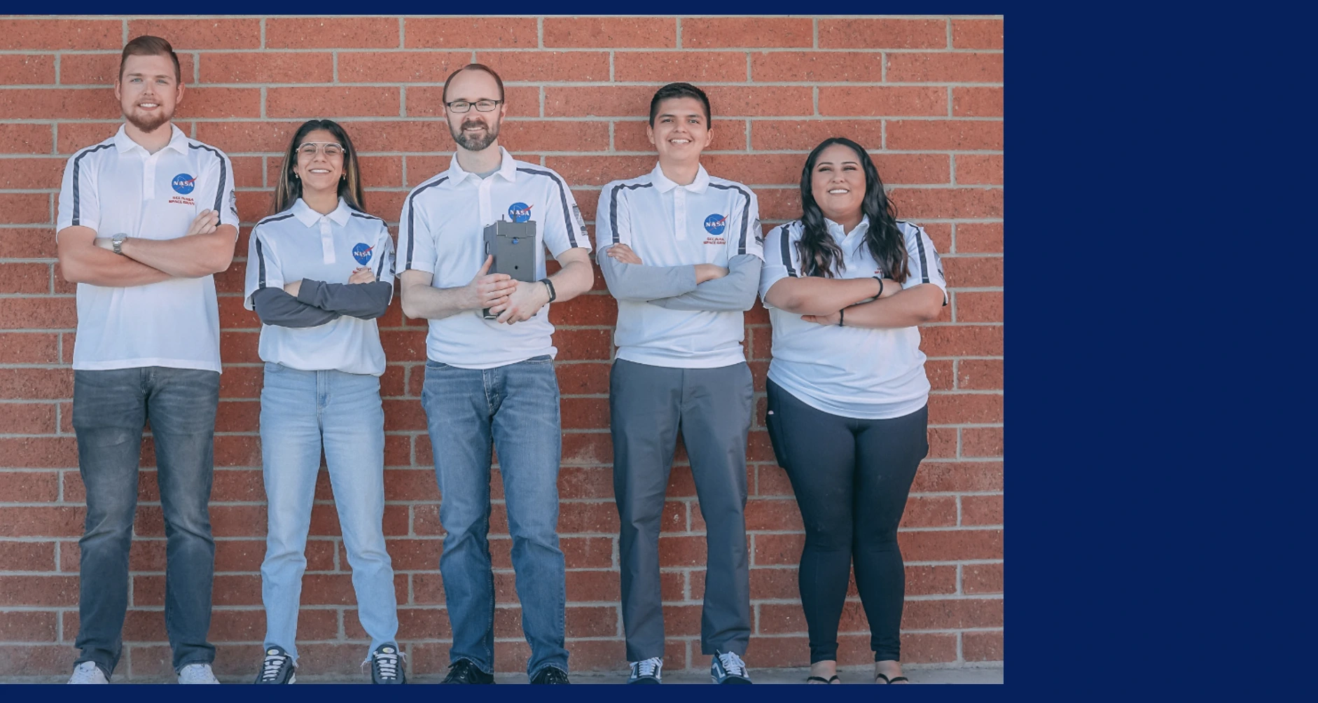 Group of 5 students on the Space Force team against brick background.