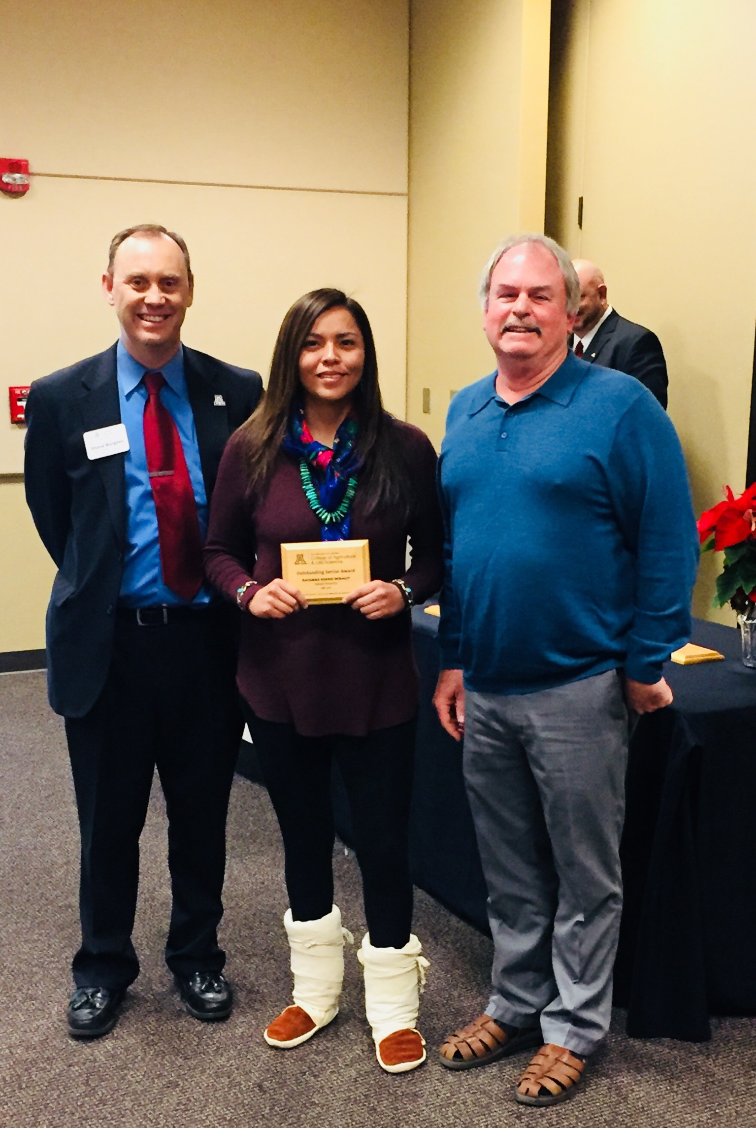 Rayanna Benally holds SNRE's Fall 2017 Outstanding Graduating Senior Award, with her mentor Steven Archer,  and Shane Burgess - Dean of College of Agriculture and Life Sciences