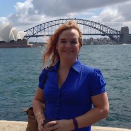 Portrait of Danielle Adams with bridge to Sydney Opera House.