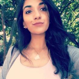 Reman Almusawi poses in front of trees